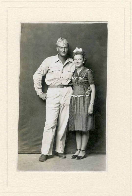 STANDING MILITARY MAN WITH WOMAN, ARM AROUND WAIST