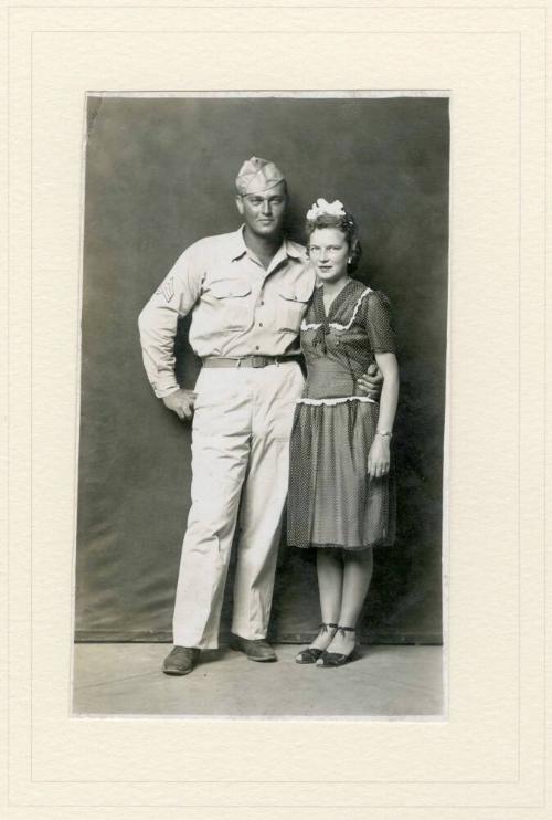 STANDING MILITARY MAN WITH WOMAN, ARM AROUND WAIST